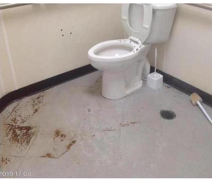 Sewage water on the floor of a bathroom.