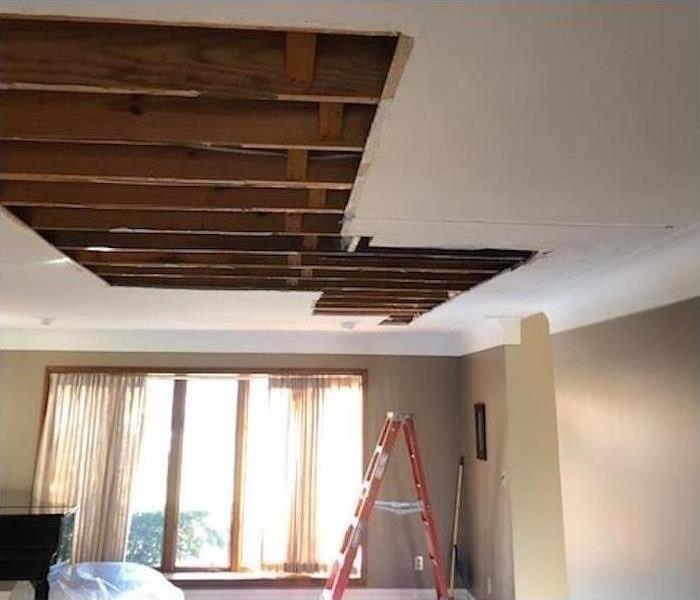 Hole in the ceiling of a living room.