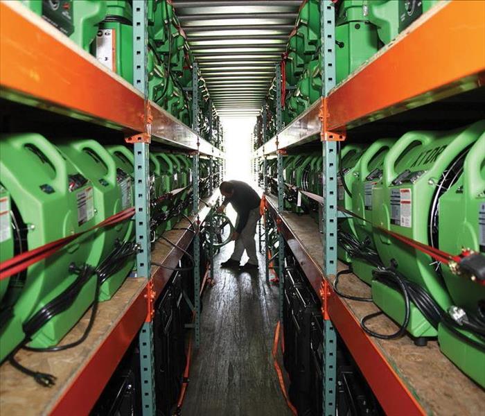 Rows of air movers in a warehouse.