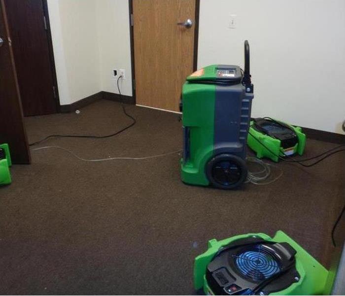 Water mitigation equipment in a room.